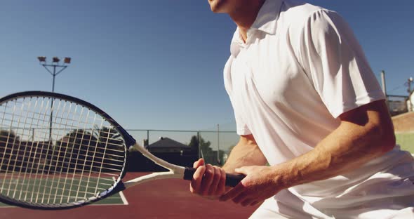 Man playing tennis on a sunny day alt