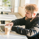 Close-up male guy portrait resting in coffee shop chatting in social networks skilled freelancer - PhotoDune Item for Sale
