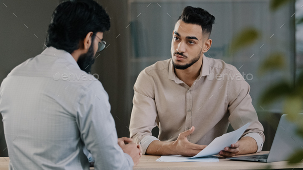 Hispanic young businessman man financial advisor agent lawyer worker consulting unknown male client - Stock Photo - Images