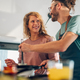 Young couple making breakfast together in the kitchen at home - PhotoDune Item for Sale