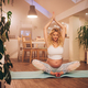 Young pregnant woman doing prenatal yoga at home on a exercise mat - PhotoDune Item for Sale