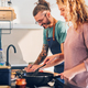 Young couple making breakfast together in the kitchen at home - PhotoDune Item for Sale