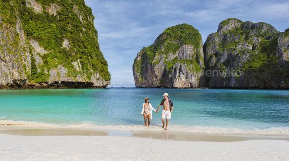 Maya Bay beach Koh Phi Phi Thailand in the morning with turqouse colored ocean - Stock Photo - Images