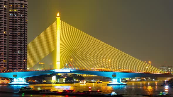 time lapse of Somdet Phra Pinklao Bridge over the Chao Phraya River at night in Bangkok, Thailand