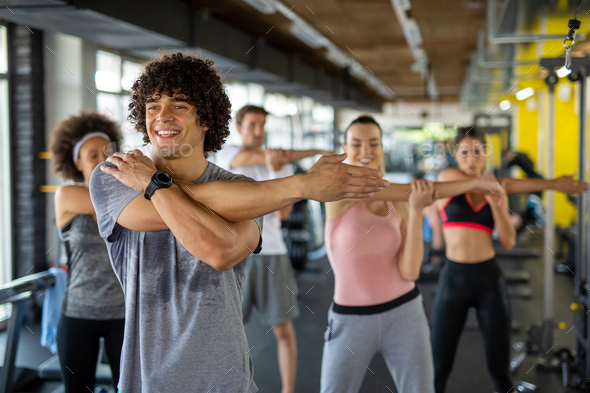 Group of young people, friends smiling and enjoy sport in gym. People exercise, work out concept. - Stock Photo - Images