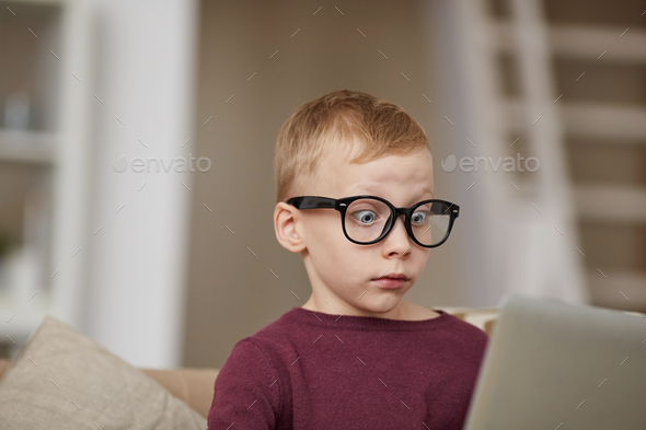 Surprised boy seeing internet advertising message