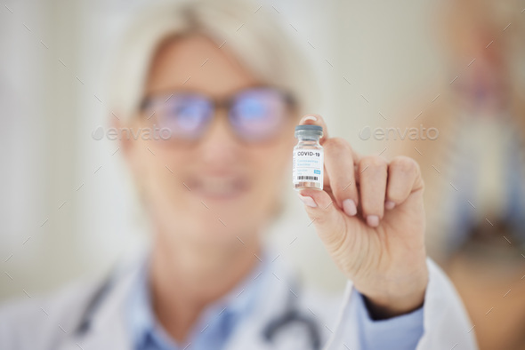 Getting the world to a better place. Shot of a doctor holding up a vial of covid vaccine.