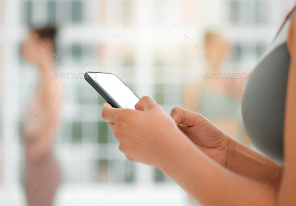 I want to download that app. Shot of an unrecognizable woman using her cellphone. - Stock Photo - Images