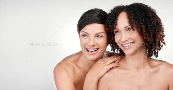 Cropped Shot Of Two Beautiful Mature Women Posing Against A Grey