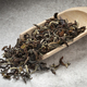 Wooden spoon with Phuguri Darjeeling Tea dried tea leaves close up - PhotoDune Item for Sale