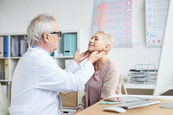 Touching patients neck during checkups - Stock Photo - Images