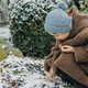 Little kid in hat and coat in winter snowy garden - PhotoDune Item for Sale