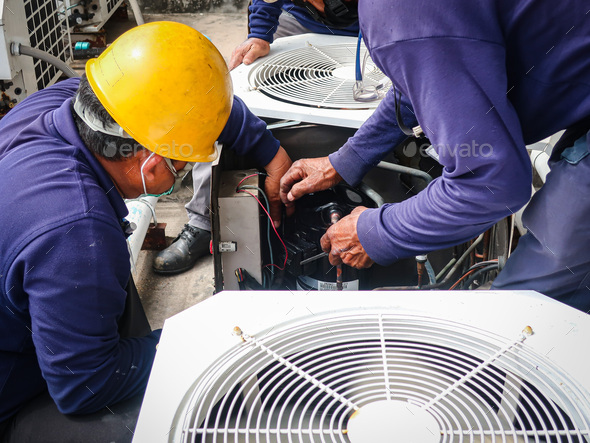 Maintenance man repair air conditional and air compressor of the factory.