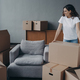 Proud single european lady in casual outfit moves. Cardboard boxes on floor. Real estate purchase. - PhotoDune Item for Sale