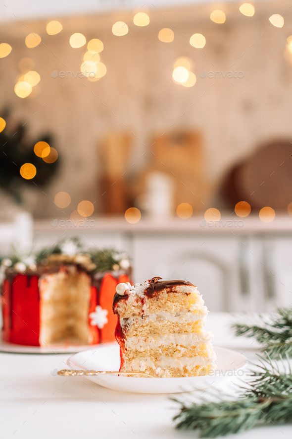 Piece of layer cake against christmas background - Stock Photo - Images