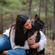 Young caucasian woman hugging her mixed breed dog at a pine forest. - PhotoDune Item for Sale