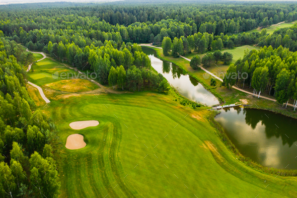 Top view of the golf course located in a wooded area Stock Photo by ...