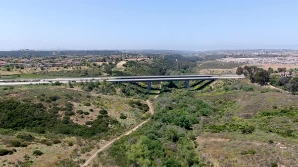 Aerial View of Road Highway Bridge, Viaduct Supports in the Valley Among the Green Hills. alt