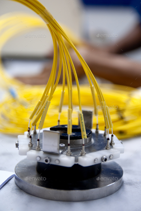 Technician cleaving an optical fiber, a crucial process for a good