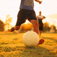 Silhouette action sport outdoors of a football player having fun playing soccer for exercise at the  - PhotoDune Item for Sale