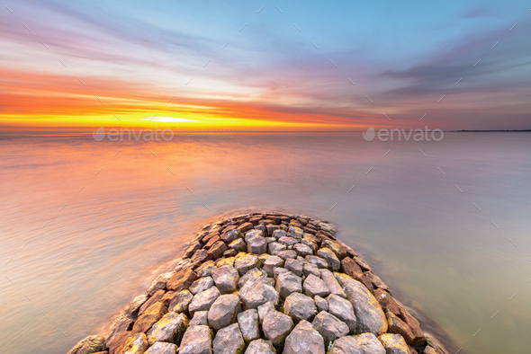 Breakwater IJsselmeer at sunset - Stock Photo - Images