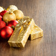 Two gold christmas gifts and christmas balls on wooden table. - PhotoDune Item for Sale
