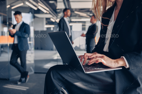 Close up of unrecognisable businesswoman working on laptop in office - Stock Photo - Images