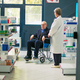 Pharmacist giving cardiology pills bottle to senior wheelchair user - PhotoDune Item for Sale