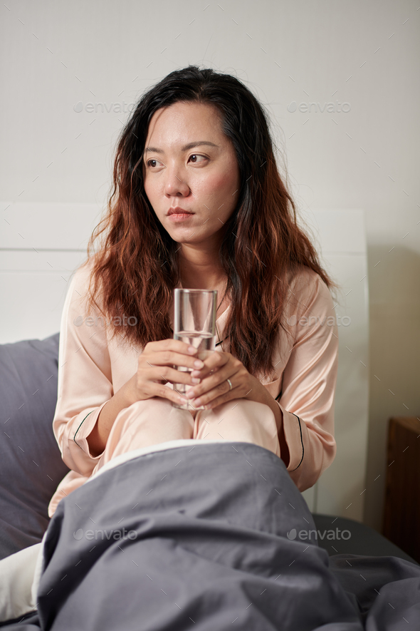 Woman Drinking Water in Bed