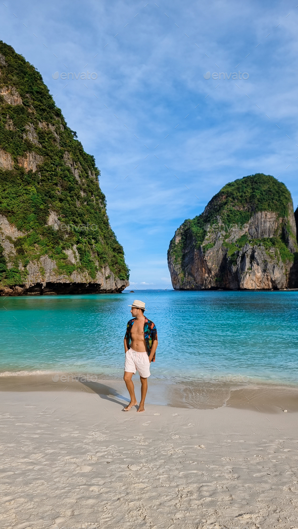 young men with swimshort and hat on the beach of Maya Bay Koh Phi Phi Thailand