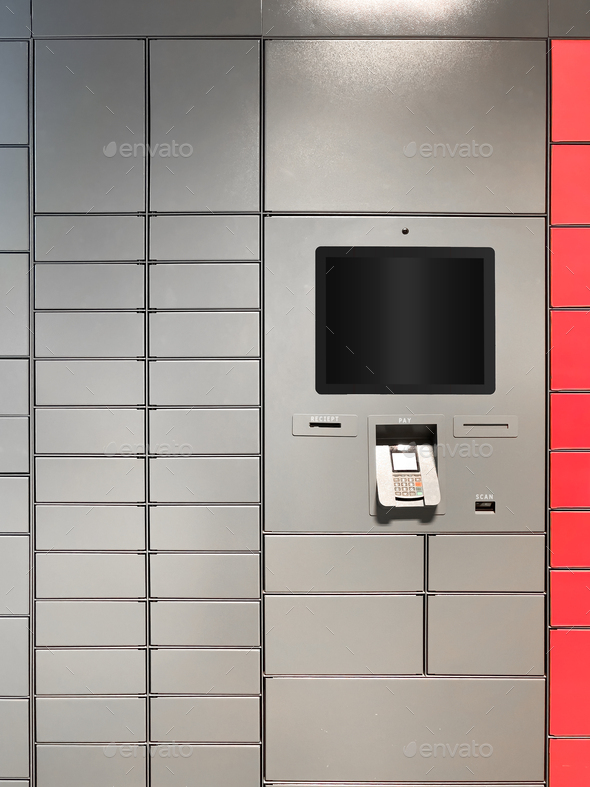 Grey automated parcel post terminal with blank screen waiting for clients - Stock Photo - Images
