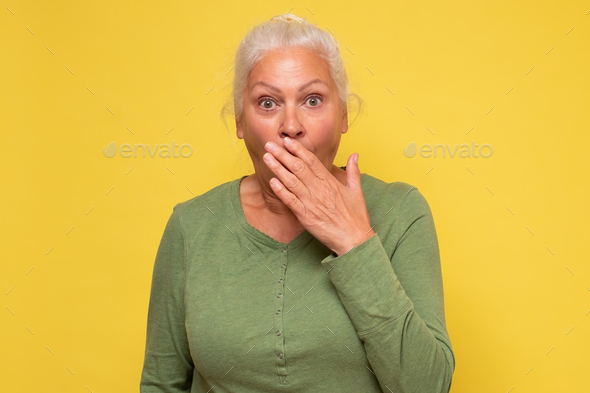 Senior beautiful woman covering mouth listening to gossips and news ...