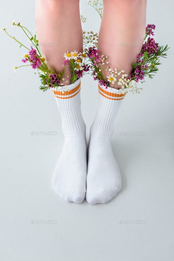 close-up partial view of female legs in socks with beautiful