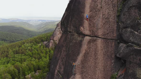 Two Climbers Make the Ascent on the Vertical Wall.