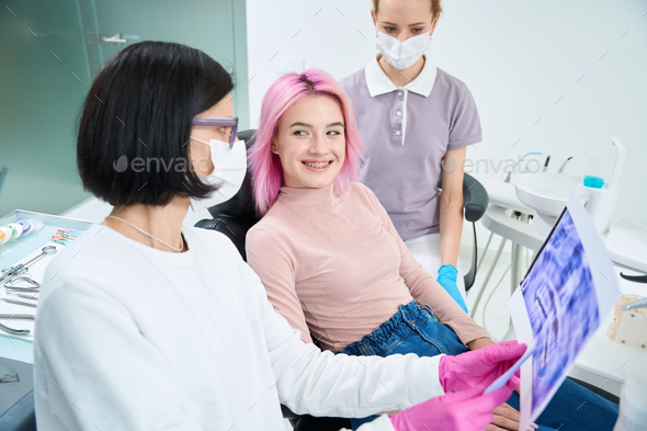 Cheerful young woman at the reception at the orthodontist - Stock Photo - Images