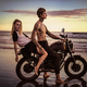couple posing on motorcycle on ocean beach - PhotoDune Item for Sale