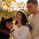Young cheerful couple walking their dog in the park - PhotoDune Item for Sale