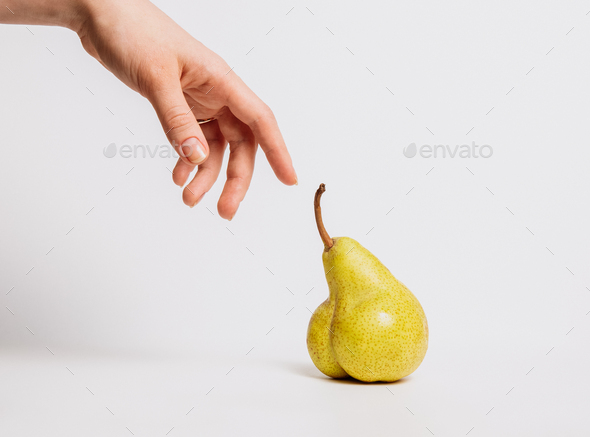 A hand touches an unusual pear-shaped remake of the renaissance and the creation of adam.