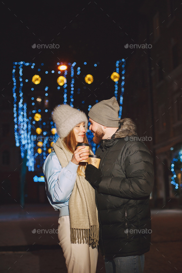 Young couple outdoor in night street at christmas time - Stock Photo - Images