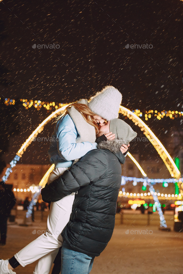 Young couple outdoor in night street at christmas time - Stock Photo - Images