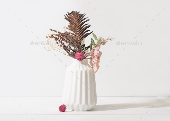 autumn and winter seasonal ikebana composition in white vase. dry flowers and leaves as home decor. - Stock Photo - Images