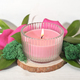 pink soy wax candle burning on a wooden saw cut podium with floral decor. Valentines day decoration - PhotoDune Item for Sale