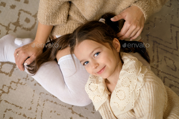 A cute beautiful  Girl is lying on mother's lap. - Stock Photo - Images