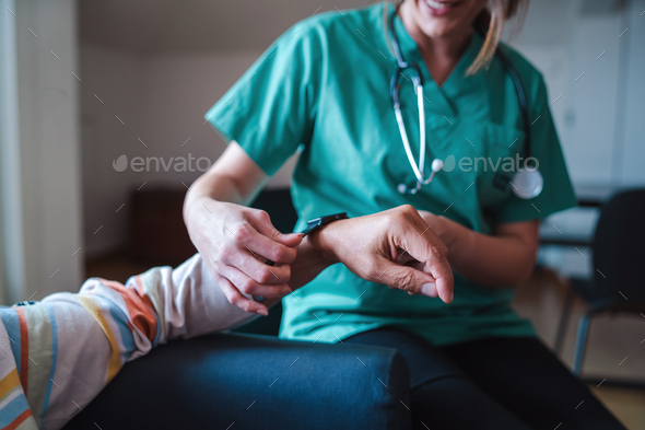 Smartwatch for health care. A woman from the medical health system wears a smartwatch for remote mon
