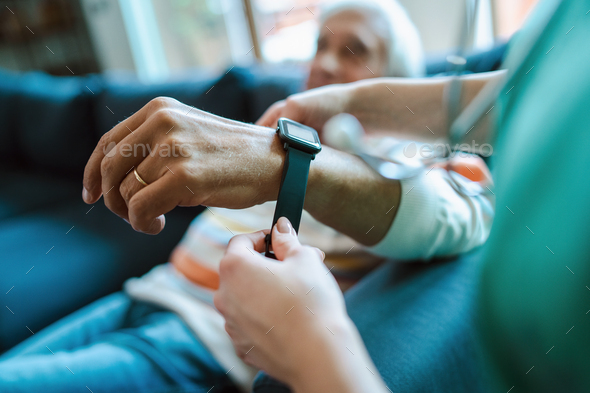 Smartwatch for assisted living. A woman from the medical health system wears a smartwatch for remote