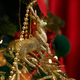 Christmas tree standing, decorated with golden deer, garlands, balls and bows. - PhotoDune Item for Sale