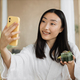 Close up portrait of ssian brunette shoulder length hair female social media influencer in bathrobe - PhotoDune Item for Sale