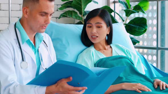 Doctor in Professional Uniform Examining Patient at Hospital alt