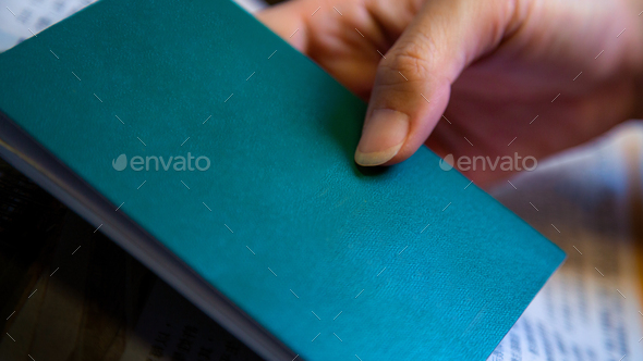 Mockup of green book on woman hand with copy space for your text or logo.