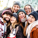 Happy multicultural guys and girls taking selfie on warm fashion clothes - PhotoDune Item for Sale